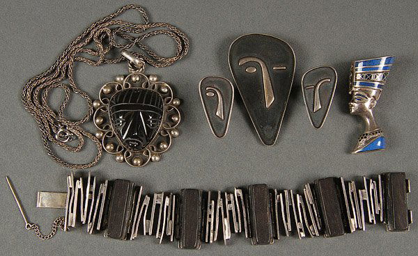 A FINE CONTEMPORARY STERLING JEWELRY GROUP: A FINE CONTEMPORARY STERLING JEWELRY GROUP, MID 20TH CENTURY. Comprising a modernist bracelet with ebony tiles stamped hand wrought RH sterling; a figural blue lapis inlaid Egyptian bust pendant, sta