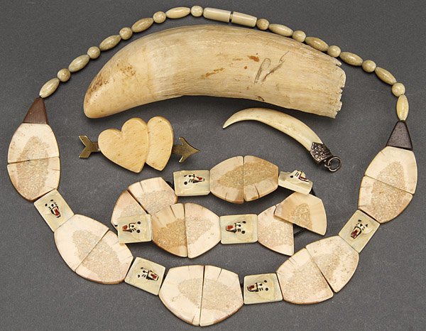 A VERY FINE ALEUTIAN ISLAND BEADED IVORY NECKLACE.: A VERY FINE ALEUTIAN ISLAND BEADED IVORY NECKLACE. Decorated with carved polar bear facial masks. Together with a matching bracelet, an ivory whale's tooth silver mounted tooth and carved ivory heart 
