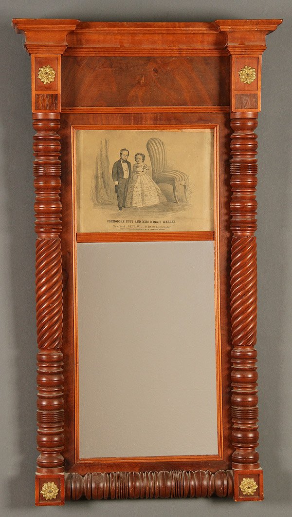 EARLY AMERICAN WALNUT AND MAHOGANY LOOKING GLASS: AN EARLY AMERICAN WALNUT AND MAHOGANY LOOKING GLASS, MID 19TH CENTURY. Below a Hitchcock print of Commodore Nutt and Miss Minnie Warren with turned columns, 39 inches x 22 inches (99 x 55.9 cm).