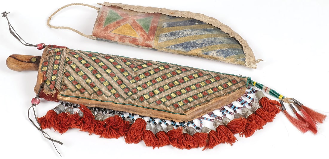 PAIR OF HIDE KNIFE SHEATHS: PAIR OF HIDE KNIFE SHEATHS. One example with loom beaded applied panel and thimble beaded drops tuffs and a plains style parfleche sheath with painted geometric patterns on both sides. Greatest length