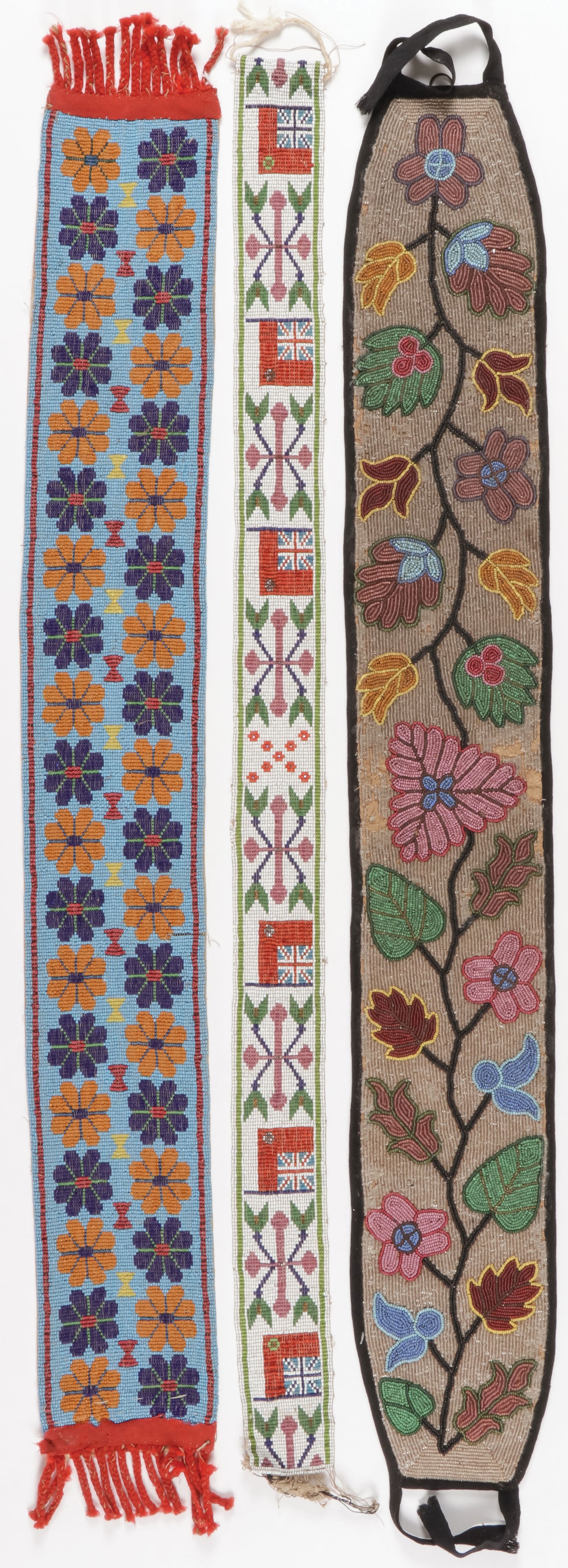 THREE GREAT LAKES BEADED BELTS, C.1900: THREE GREAT LAKES BEADED BELTS, C.1900. Including a Chippewa man's belt in floral pattern with black piping, a Chippewa sash or belt, loom-beaded with flower heads on blue field, and a loom-beaded bel