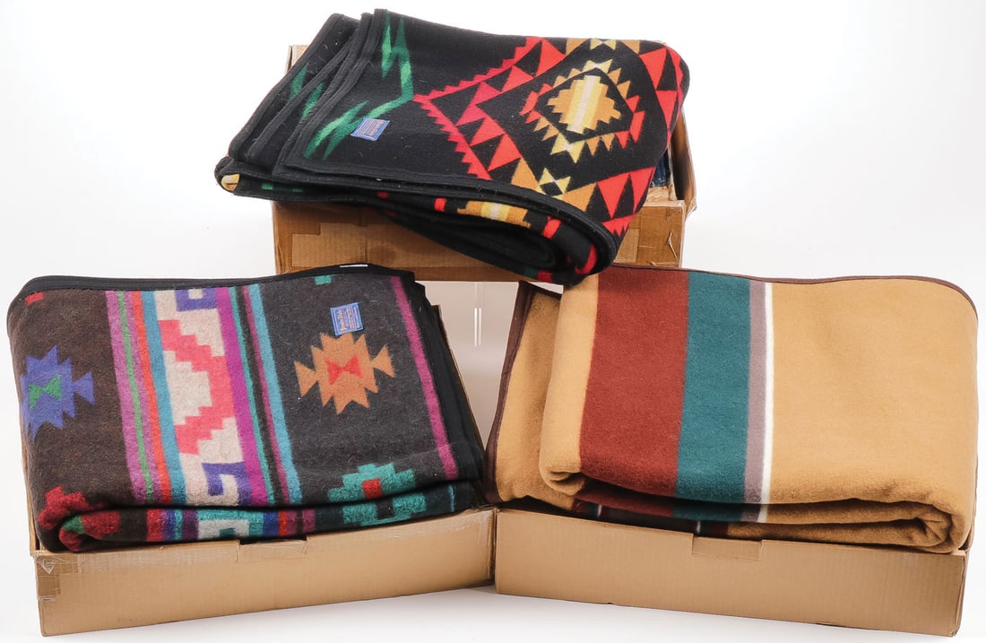 THREE PENDLETON BLANKETS: THREE PENDLETON BLANKETS. Each of different pattern or design and each in original box. Like new. 64 inches x 80 inches. SHIPPING NOTICE: Except for large, oversized items, Jackson's is your sole and