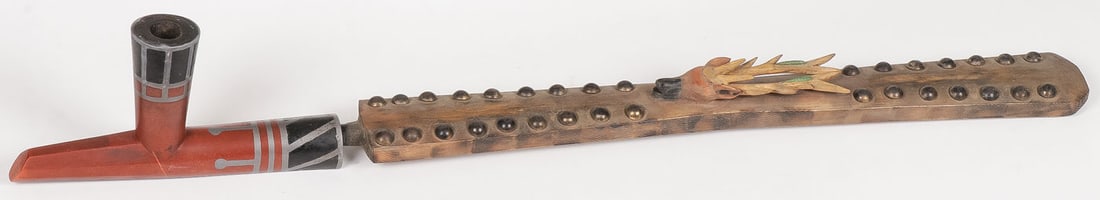 PLAINS CATLINITE PIPE AND STEM: PLAINS CATLINITE PIPE AND STEM. The bowl of traditional form with black and red pipestone and inlaid pewter banding. Together with a carved flared stem with integral carved and polychrome elk head, br