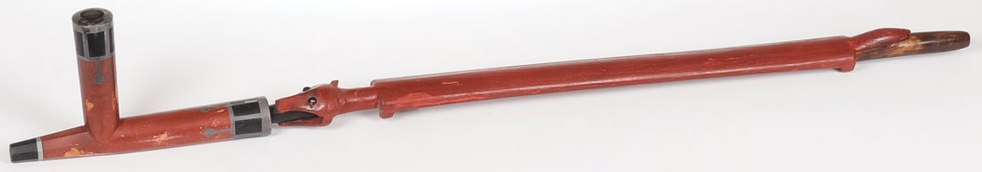 PLAINS PIPE AND STEM: PLAINS PIPE AND STEM. Comprising a large catlinite and black stone pipe bowl with pewter banding and a carved beaver effigy pipe stem. Length of bowl 8 inches, overall length of stem 25.75 inches.SHIP