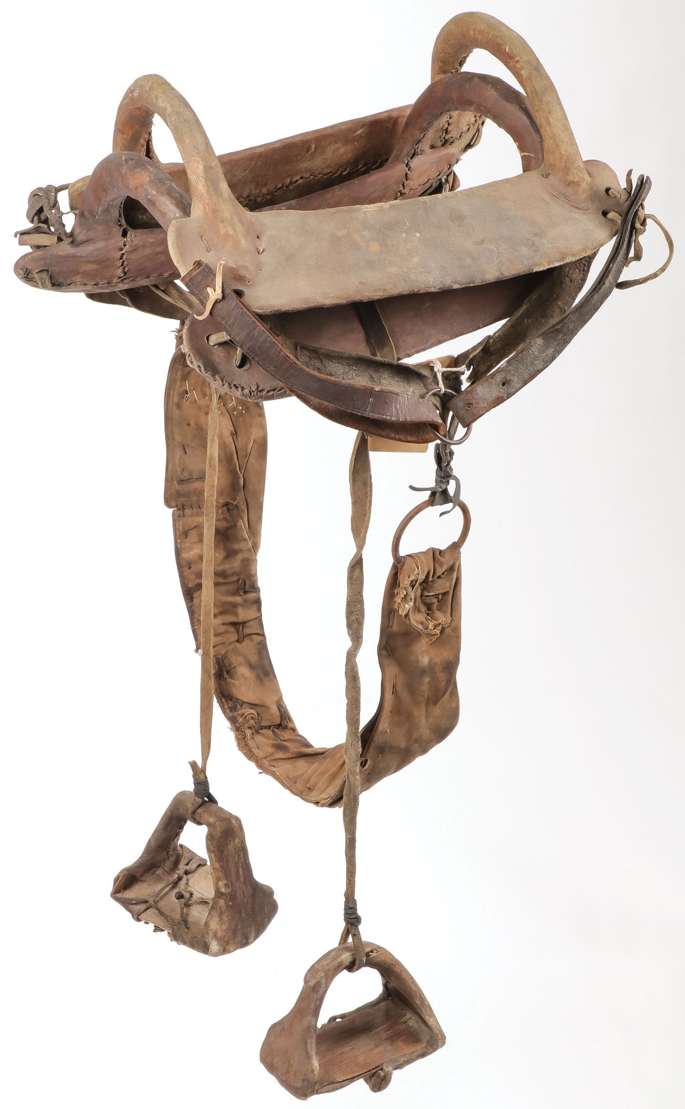 PAIR PLAINS HIDE WRAPPED SADDLES, 19TH C: PAIR PLAINS HIDE WRAPPED SADDLES, 19TH C. Of traditional arch frame design, sinew-sewn and hide wrapped. One with wood stirrups as shown. Greatest length 18 inches. SHIPPING NOTICE: Except for large,