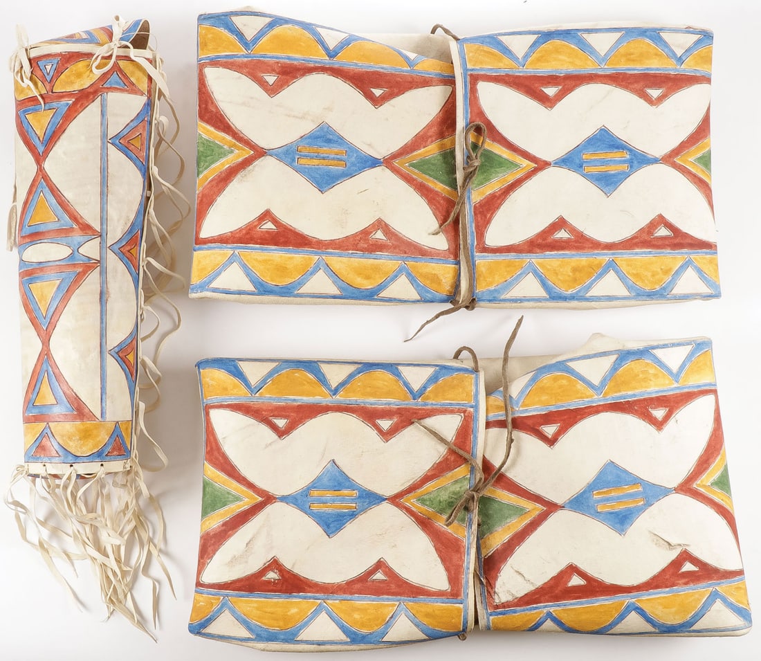 THREE PLAINS STYLE PARFLECHE CONTAINERS: THREE PLAINS STYLE PARFLECHE CONTAINERS. Comprising a cylinder with fringe and two envelopes with traditional designs as shown. Contemporary. SHIPPING NOTICE: Except for large, oversized items, Jacks