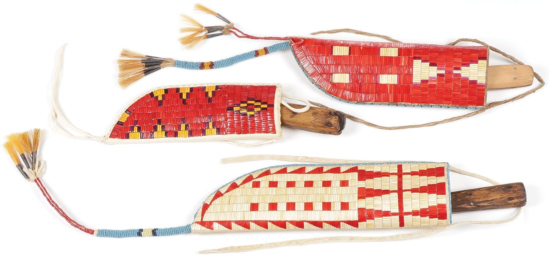 THREE PLAINS STYLE QUILLED KNIFE SHEATHS: THREE PLAINS STYLE QUILLED KNIFE SHEATHS. Geometrical quilled patterns on hide bodies, two with beaded horsehair cone drops. Contemporary. Greatest overall length including drop 21.5 inches. SHIPPING 