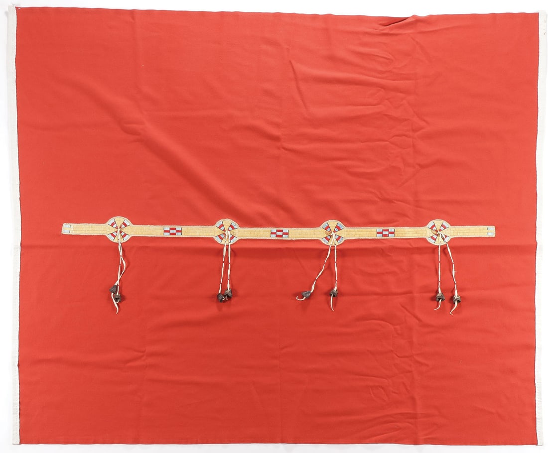 WOOL BLANKET AND APRON: WOOL BLANKET AND APRON. Comprising a red wool Plains style blanket with quilled strip and deer hoof drops and cloth edging, 73.5 inches x 60.5 inches (contemporary), a wool apron with ribbon silk edgi