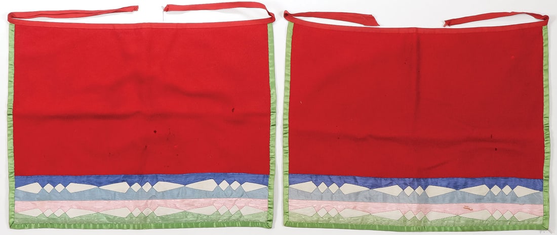 PAIR WINNEBAGO SILK & WOOL APRONS, C. 1890: PAIR WINNEBAGO SILK & WOOL APRONS, C. 1890. Of traditional design with ribbon silk applique and piping, some mothing. Very attractive. Each approximately 15.5 inches x 20 inches. SHIPPING NOTICE:Exc