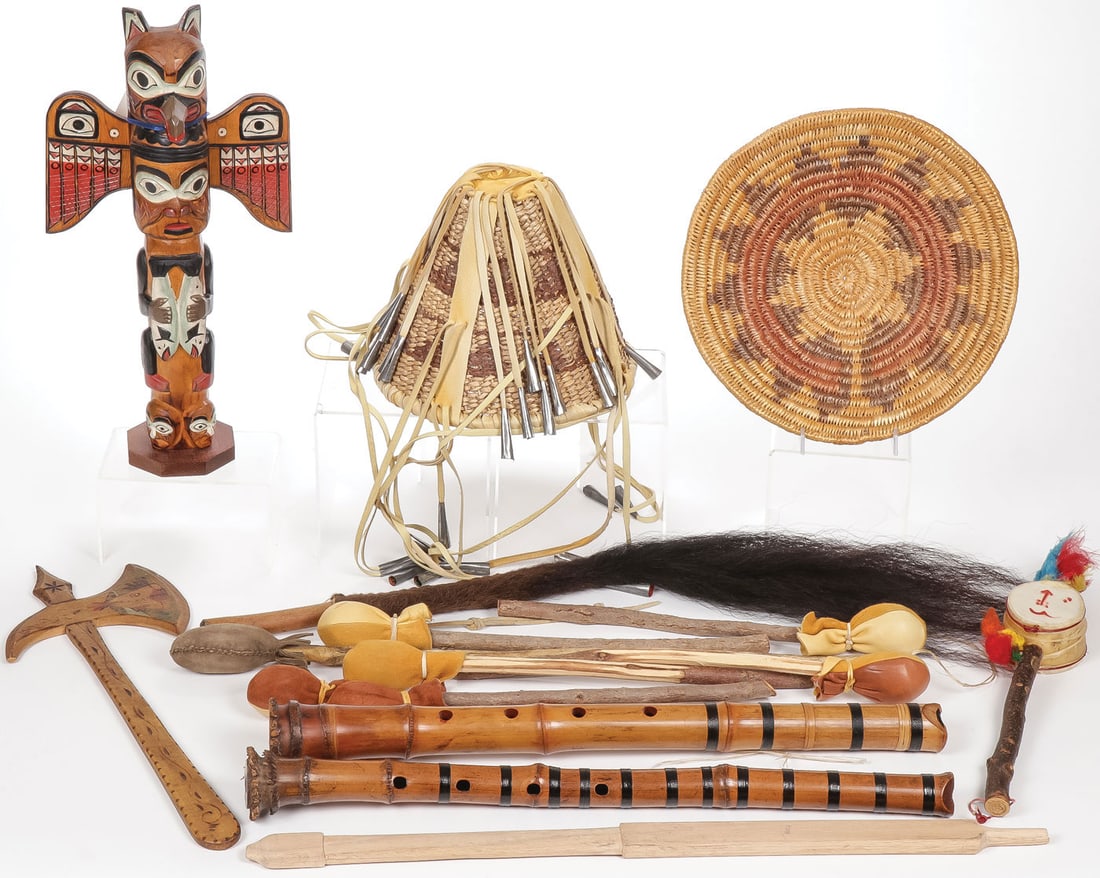 MIXED NATIVE CULTURES GROUP: MIXED NATIVE CULTURES GROUP. Comprising sixteen individual pieces including a carved and polychrome totem, signed on base Patrick Seale, a hide rattle, a buffalo tail quirt, an undecorated pipe stem, 