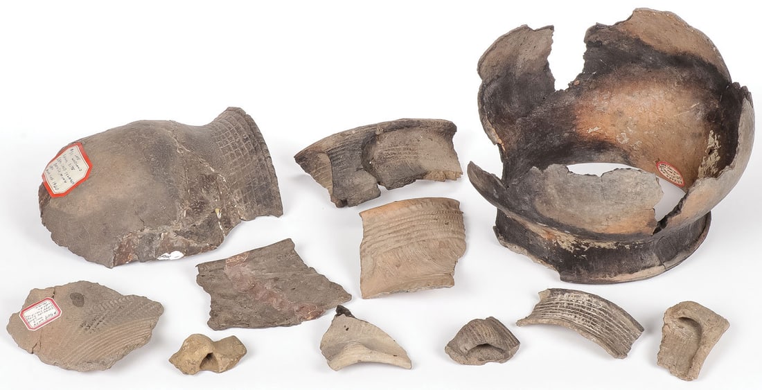 GROUP OF WOODLAND POTTERY CHARDS: GROUP OF WOODLAND POTTERY CHARDS. Comprising eleven individual pieces, including two partially restored vessels with labels attributing to Woodlands sites. Greatest measurement 9.5 inches.SHIPPING NOT