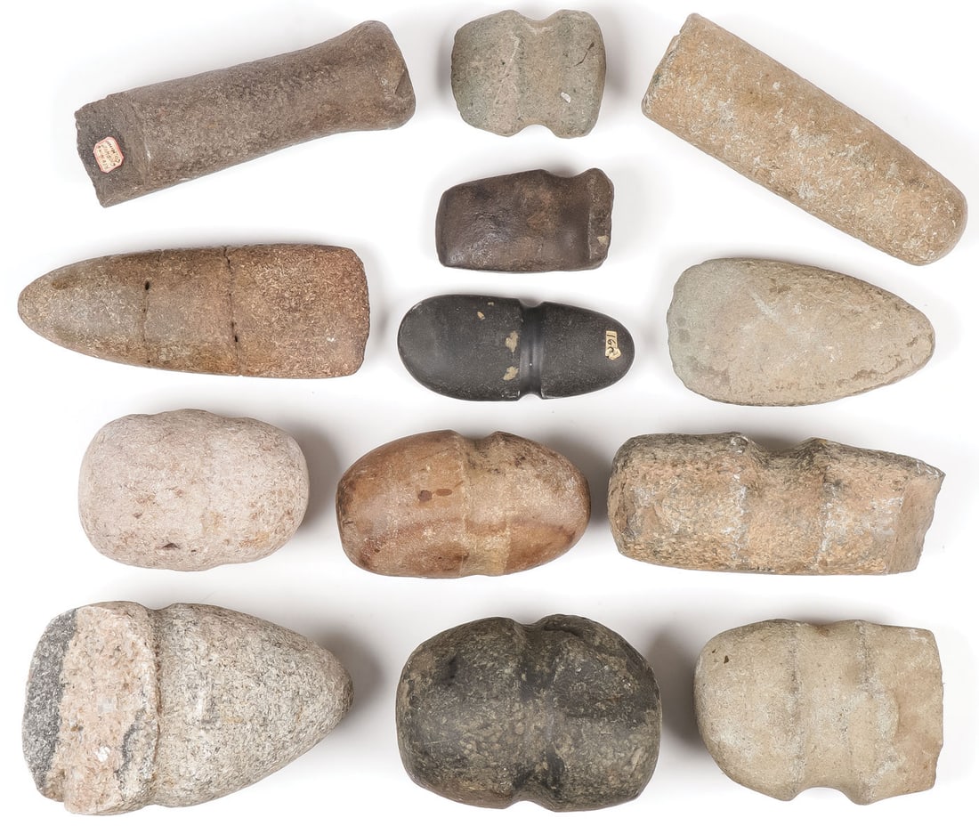 THIRTEEN STONE TOOLS: THIRTEEN STONE TOOLS. Comprising a good variety, including pestles, malls, axe heads, and celts in various states of condition as shown. Greatest length 7 inches. SHIPPING NOTICE: Except for large, ov