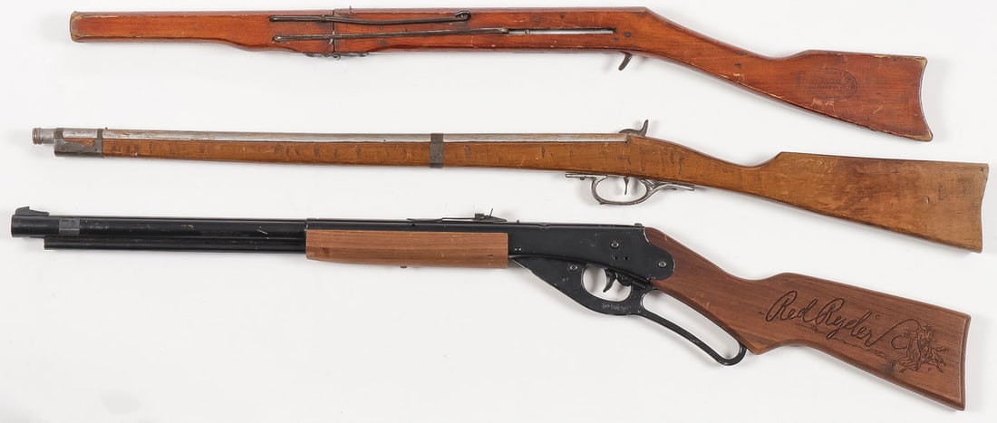 TWO AIR RIFLES AND PROP GUN: TWO AIR RIFLES AND PROP GUN. Comprising an early all wood Markham air rifle, a Daisy Red Ryder model 1938B, and a wood and metal percussion style rifle cap gun. Greatest length 36 inches.SHIPPING NOTI