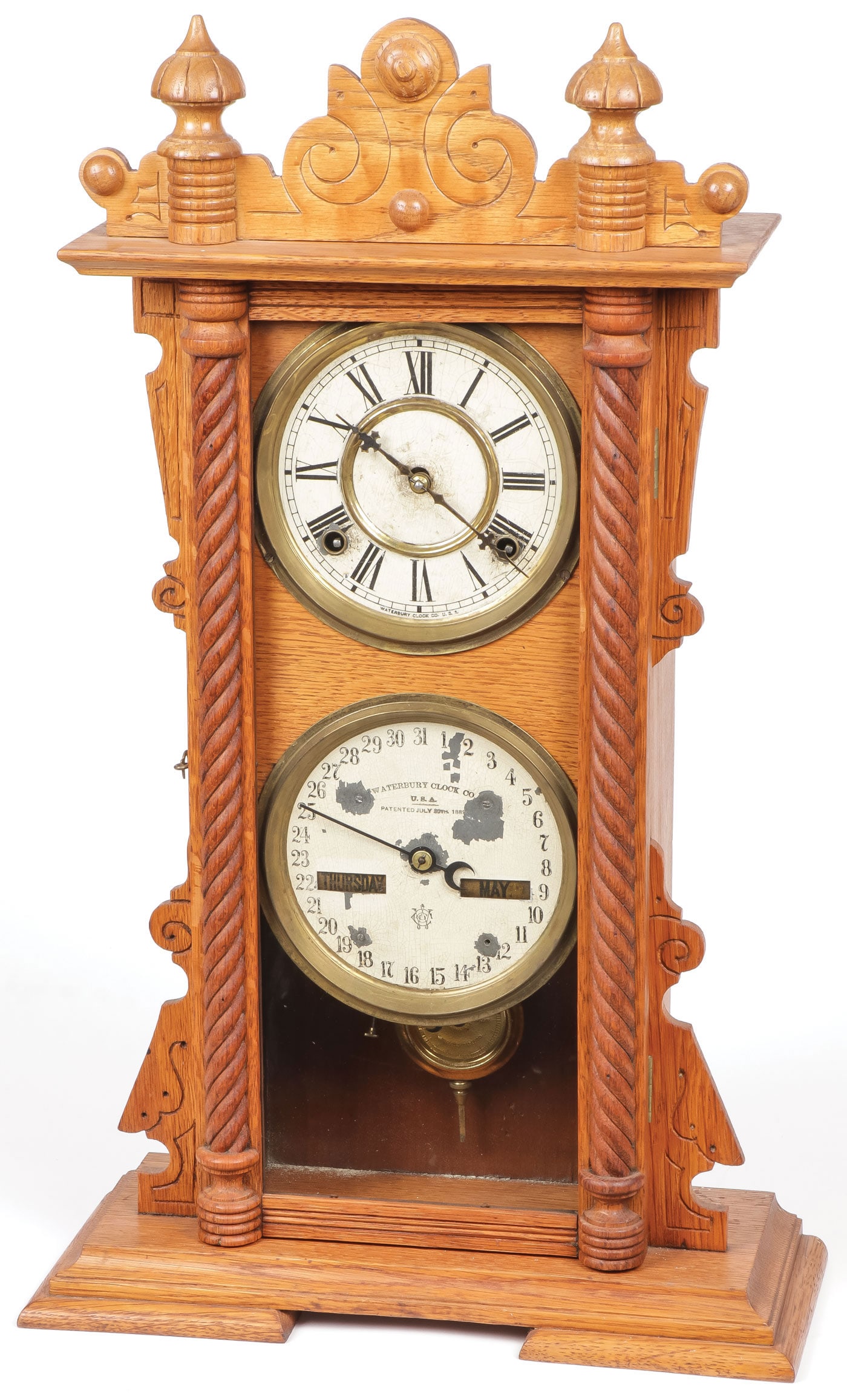 Waterbury Calendar Shelf Clock: Waterbury Calendar Shelf Clock. Waterbury Clock Co., Waterbury, Conn., "Calendar No. 40", shelf clock, oak case, painted dials, Maltese hands, 8-day time and strike brass movement with a patented perp