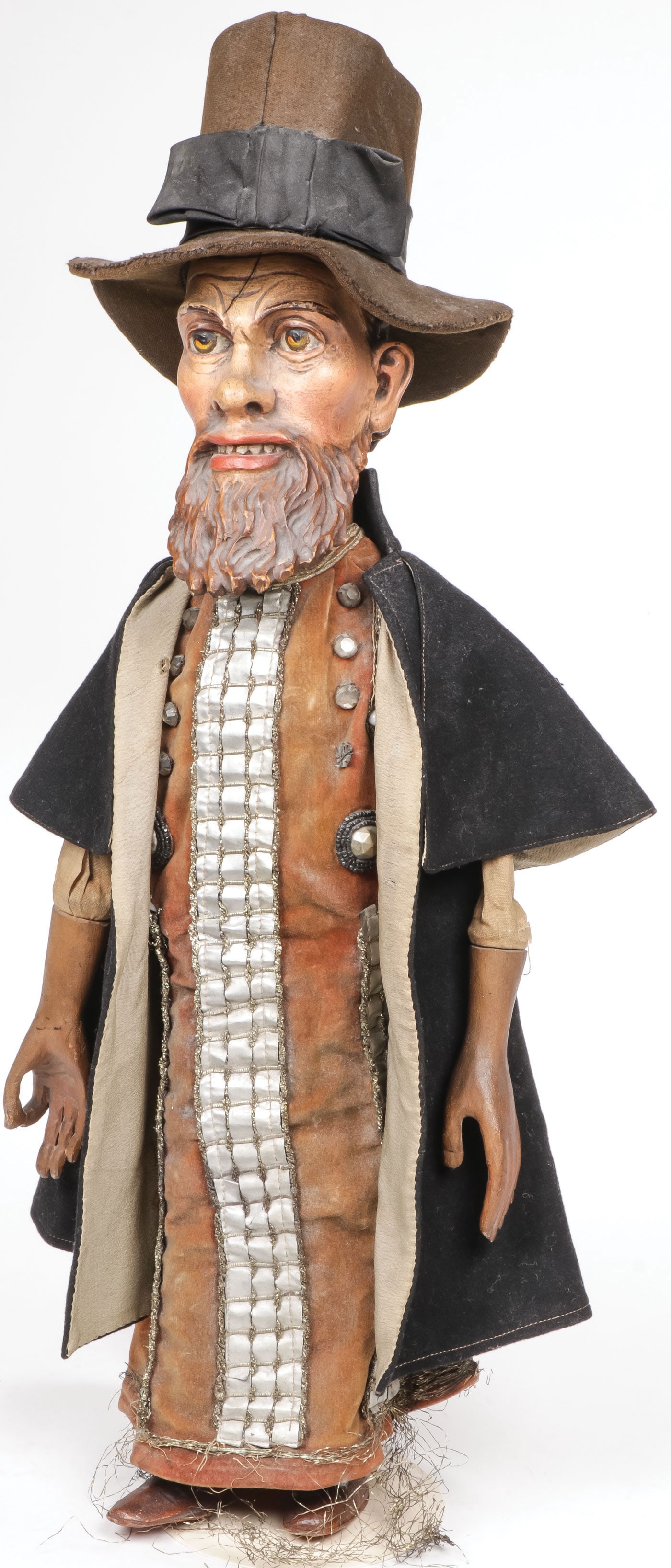 GERMAN CARVED WOOD PUPPET CIRCA 1890: GERMAN CARVED WOOD PUPPET CIRCA 1890. Finely carved and painted wood head with wood hands and wooden legs. Dressed in likely the original embroidered costume, with felt cape and stove pipe hat as show