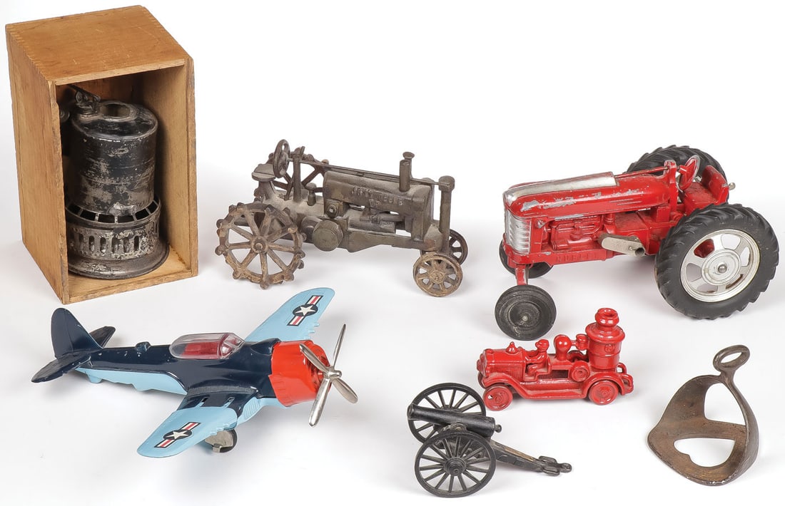 VINTAGE TOY GROUP: VINTAGE TOY GROUP. Comprising a Hubley red-painted tractor, a cast iron John Deere tractor, a Hubley diecast aircraft with folding wings, a cast iron civil war cannon on carriage, a cast iron red pain