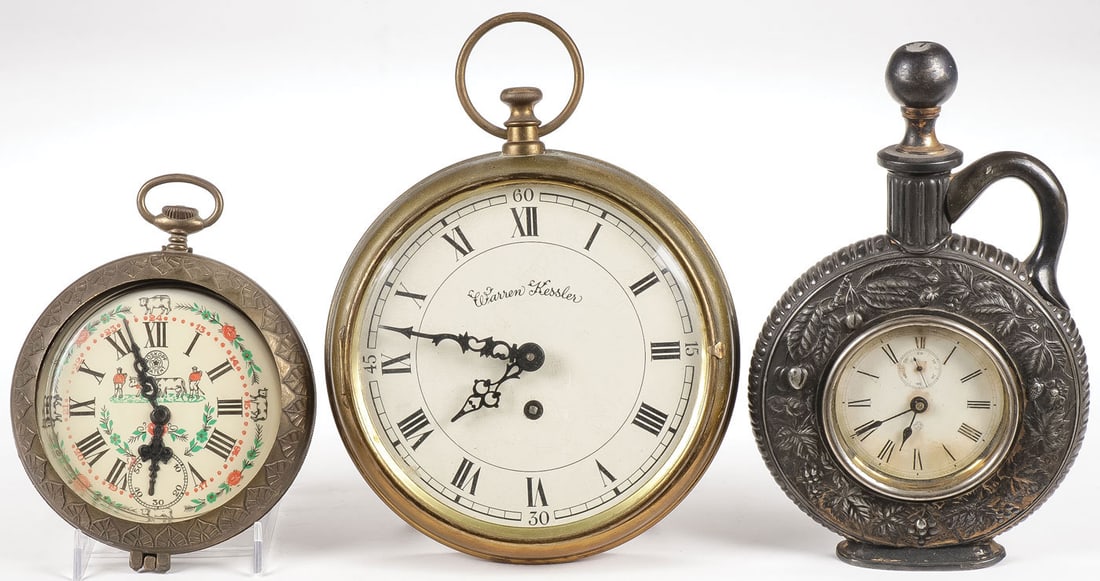 VINTAGE NOVELTY CLOCKS: VINTAGE NOVELTY CLOCKS. Comprising an Ansonia bottle-form key-wind alarm clock, takes a wind and advances. A Warren Kessler novelty key-wind pocket watch alarm clock, and a Roskopf pocket watch ashtra
