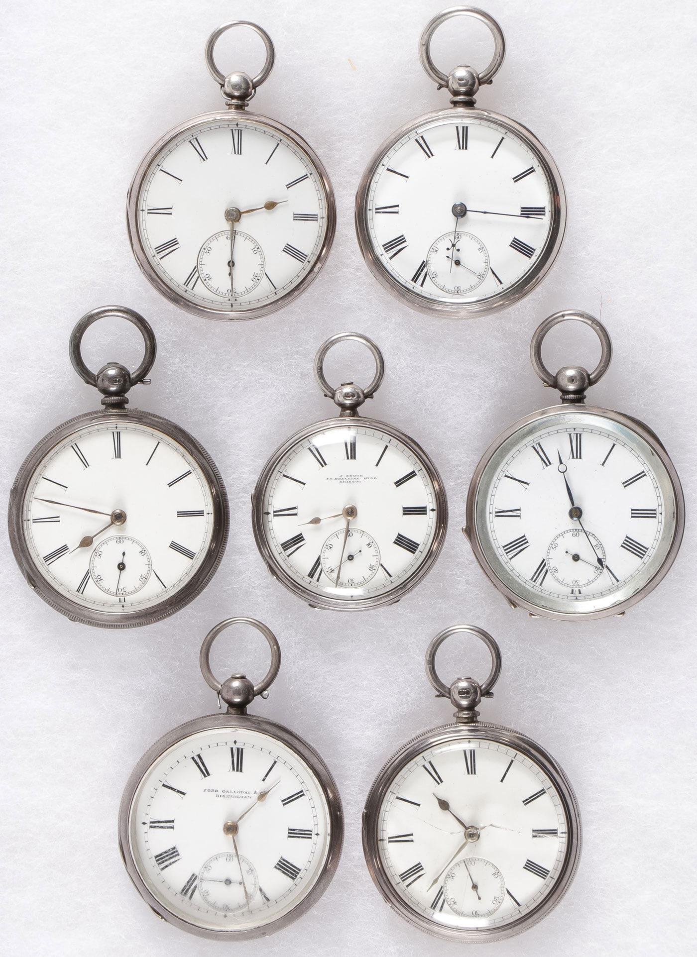 7 SILVER OPEN FACE KEY WIND POCKET WATCHES: 7 SILVER OPEN FACE KEY WIND POCKET WATCHES, 19th C. From top to bottom left to right, an English silver case, London hallmarks, date letter 1860, white enamel dial, fusee movement marked Ja Rattray Du