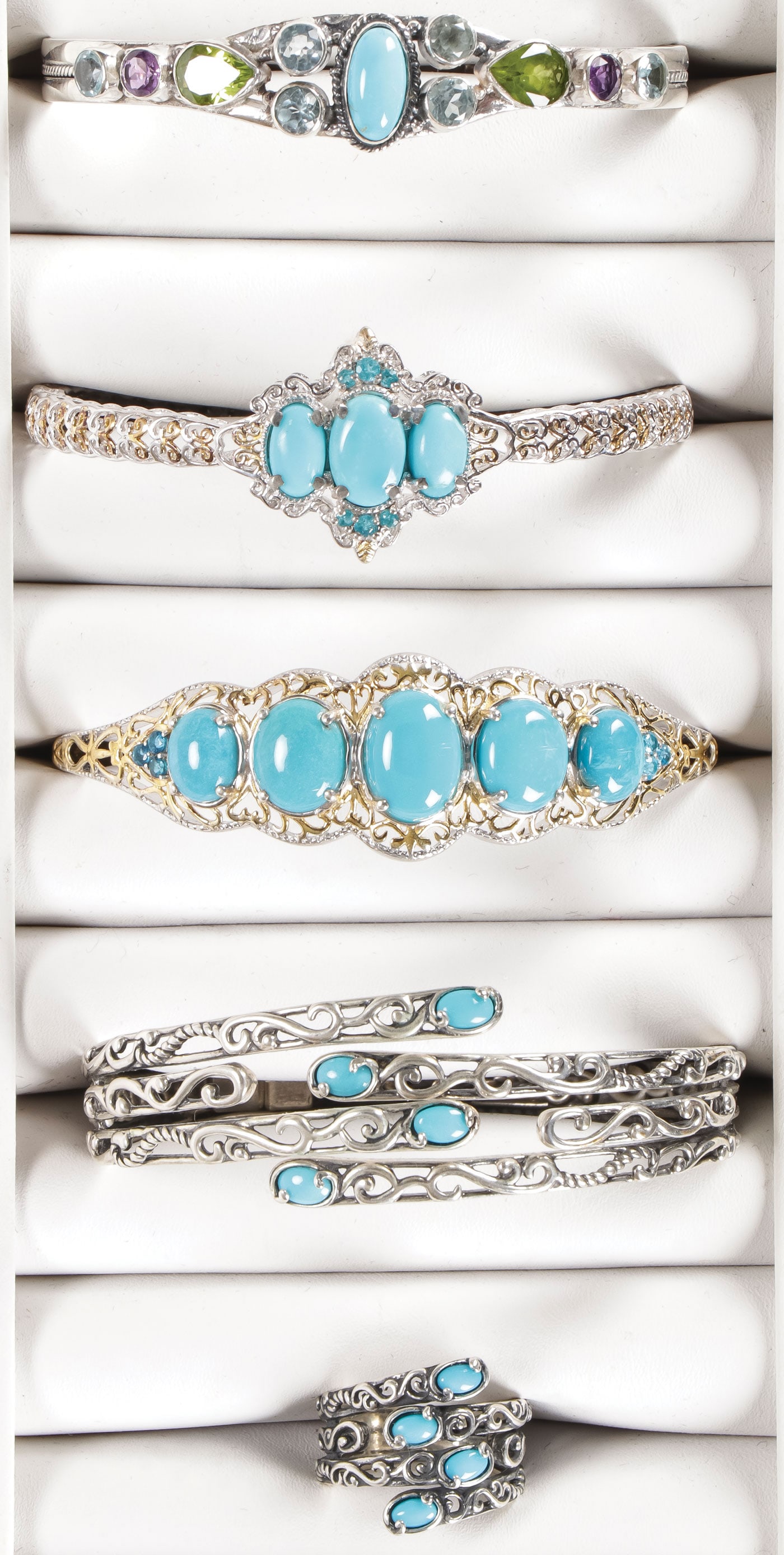 ATTRACTIVE SILVER & TURQUOISE JEWELRY LOT: ATTRACTIVE SILVER & TURQUOISE JEWELRY LOT. Comprising five individual pieces, including three silver bracelets set with turquoise main stones, and embellished with varicolored gemstones and gilt decor