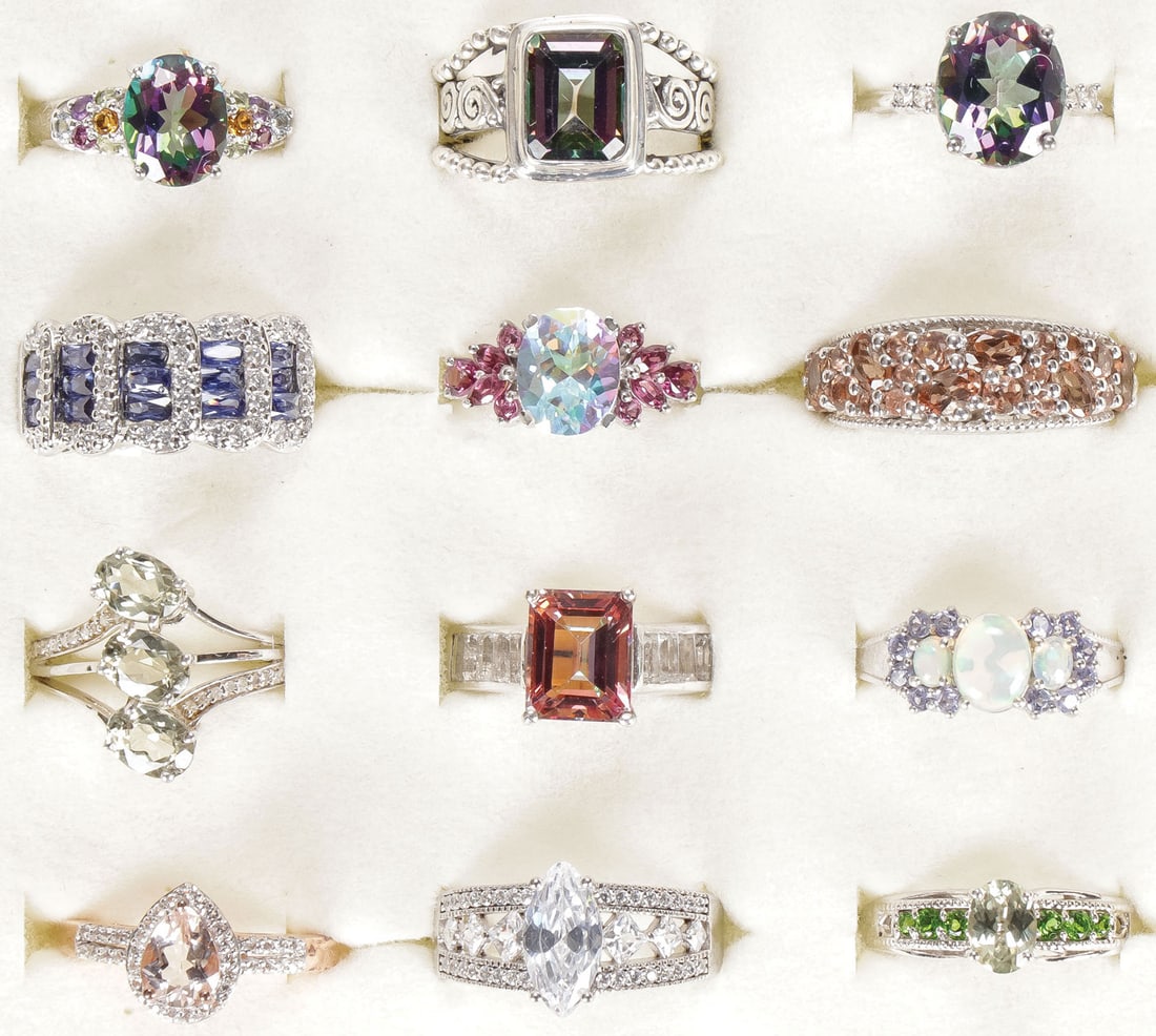 12 STERLING WOMAN'S FASHION RINGS: 12 STERLING WOMAN'S FASHION RINGS. Comprising 12 sterling silver rings set with a variety of precious and semi-precious gemstones, including morganite, opal, mystic topaz, Rhodolite, Northern Lights E
