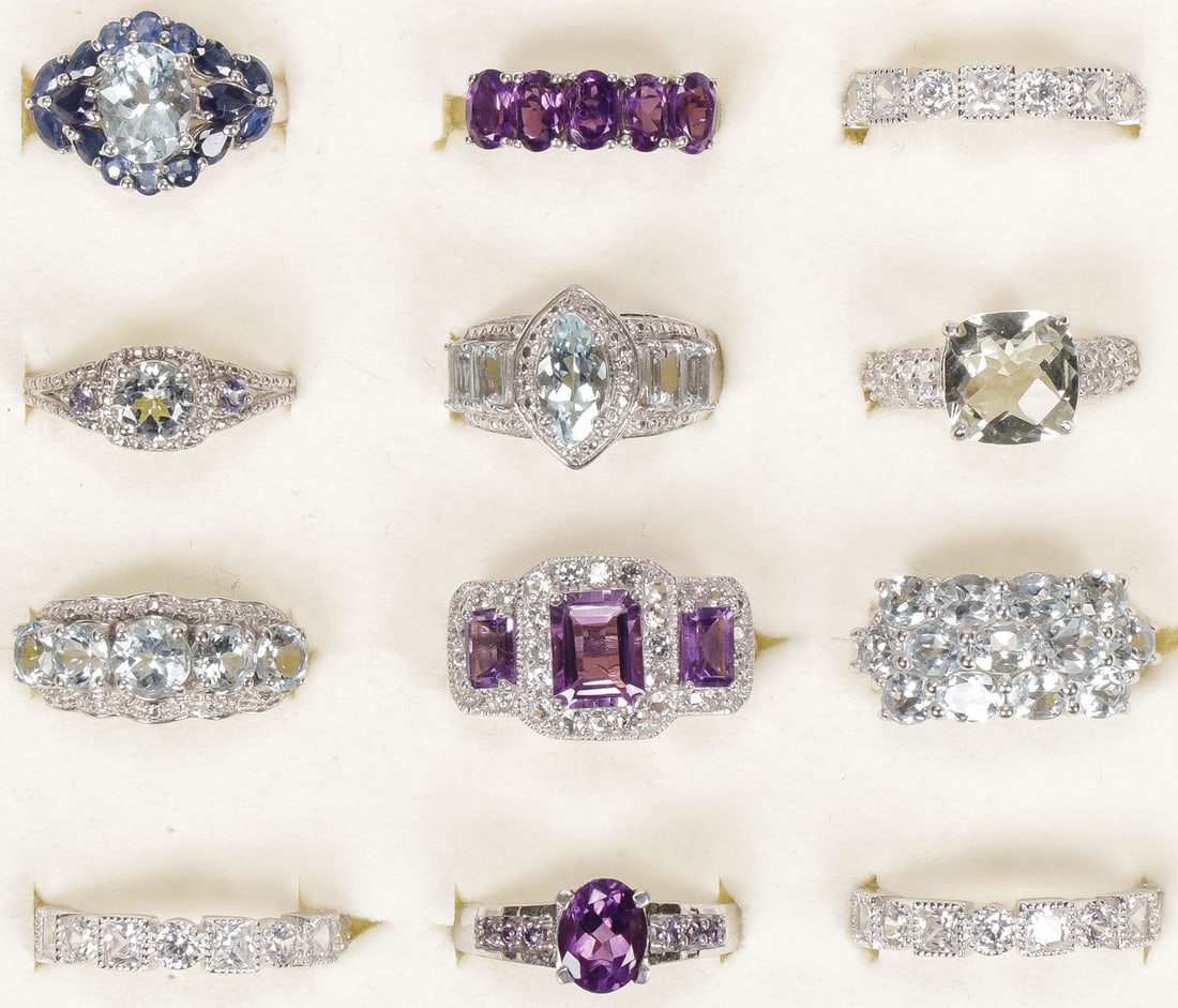 12 STERLING WOMAN'S FASHION RINGS: 12 STERLING WOMAN'S FASHION RINGS. Comprising 12 sterling silver rings set with a variety of precious and semi-precious gemstones, including aquamarine and others, some with accent diamonds, most size