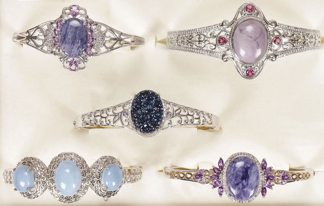 FIVE WOMEN'S FASHION BRACELETS: FIVE WOMEN'S FASHION BRACELETS. Including three silver examples and two in ‘platinum bond brass,' set with a variety of semi-precious gemstones as shown, including Utah Tiffany stone, cobalt blu