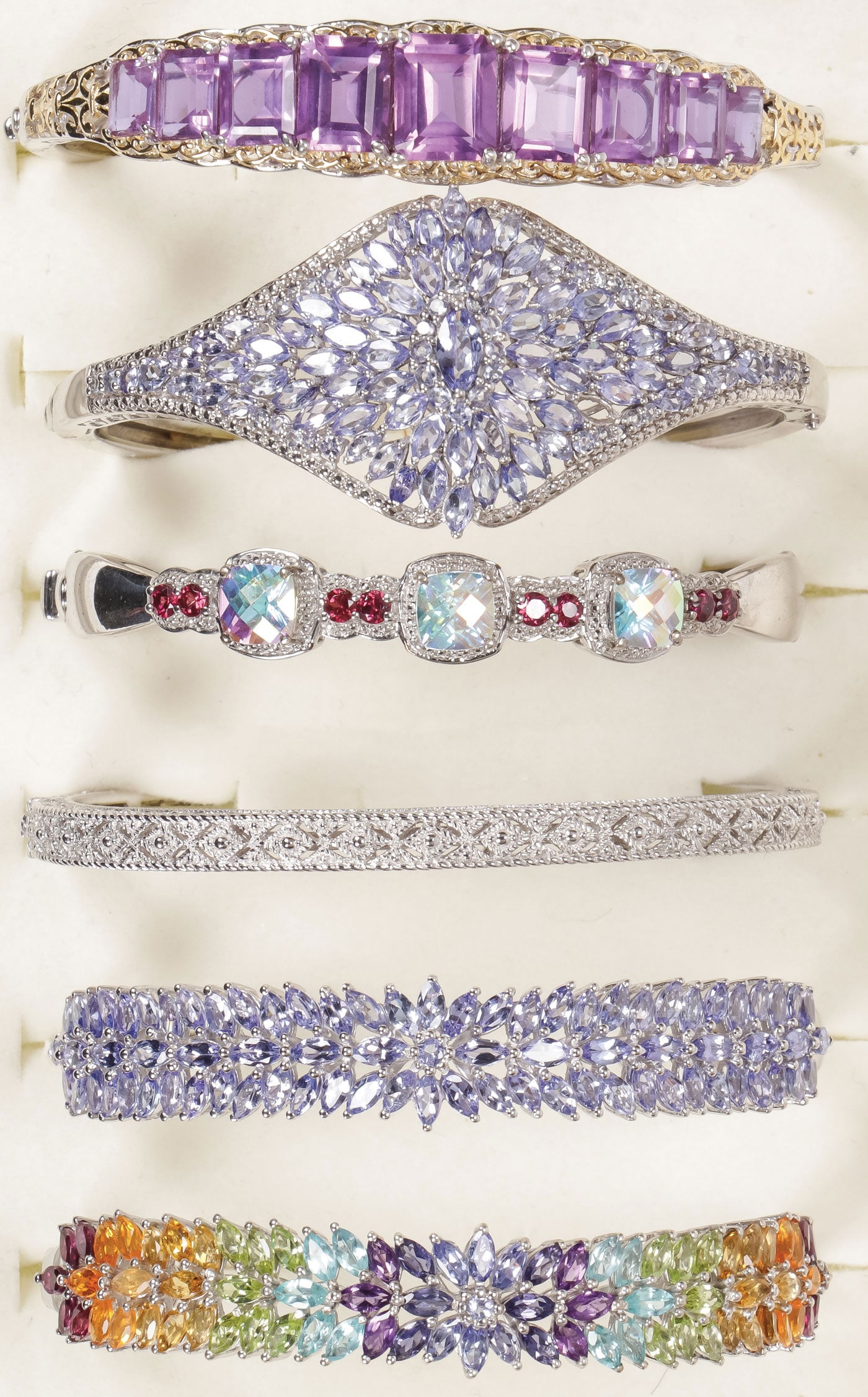 WOMEN'S LOVELY GEMSTONE BRACELET GROUP: WOMEN'S LOVELY GEMSTONE BRACELET GROUP. Comprising five lovely women's gem set bracelets, four in silver and one in ‘platinum bond brass,' set with a variety of precious and semi-precious gemsto