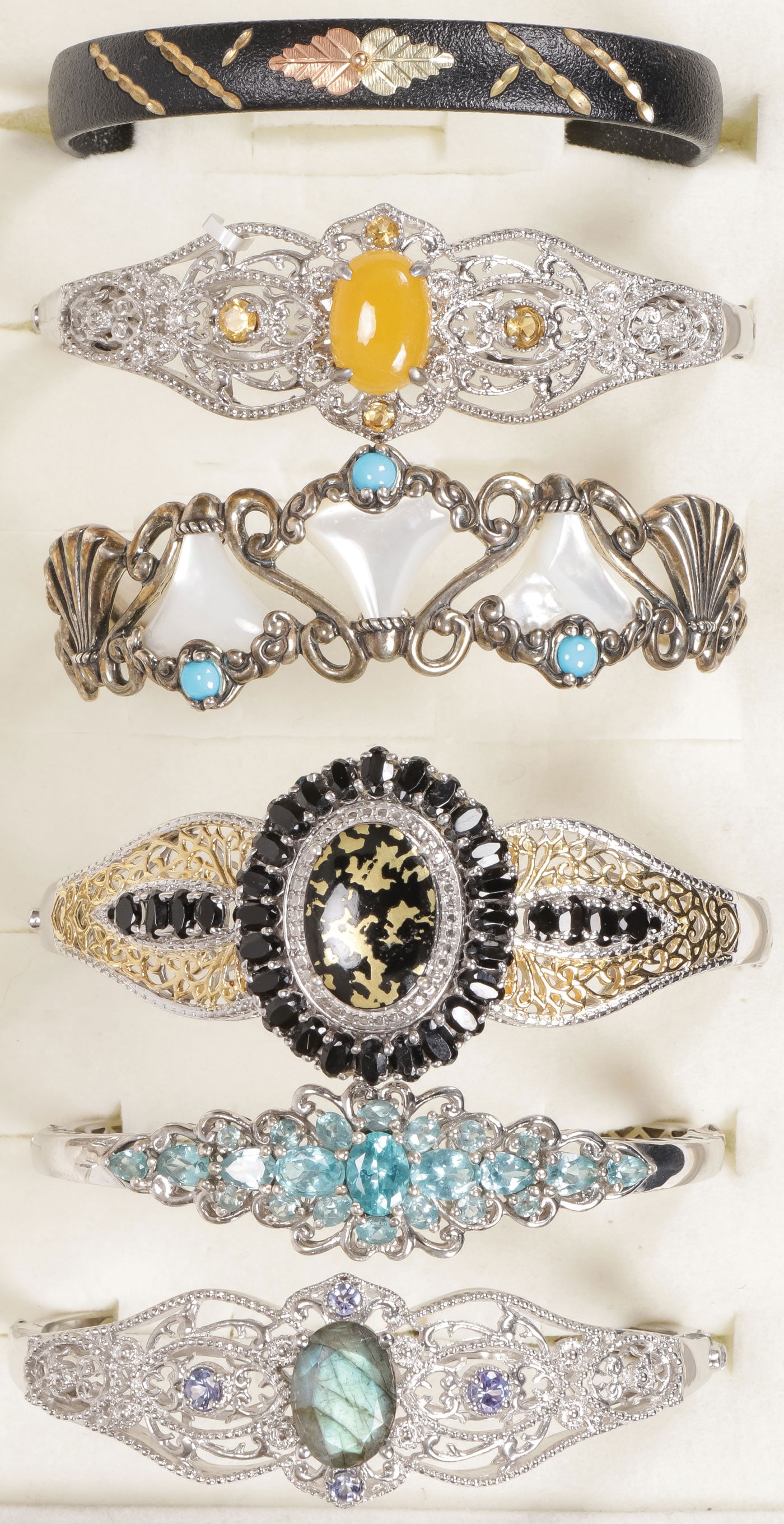 WOMEN'S STYLISH BRACELET GROUP: WOMEN'S STYLISH BRACELET GROUP. Comprising six bracelets including three silver examples and two ‘platinum bond brass' examples set with a variety of semi-precious gemstones including labradorit