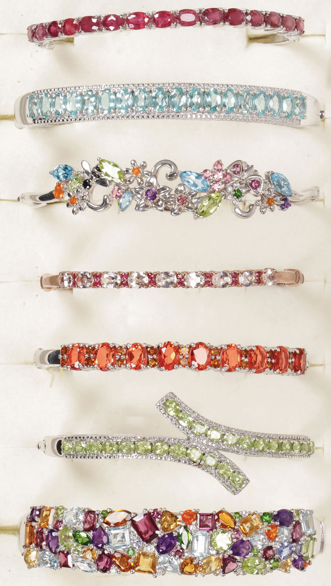 7 PRETTY SILVER & GEM SET BRACELETS: 7 PRETTY SILVER & GEM SET BRACELETS. Comprising seven silver bracelets set with a variety of precious and semi-precious gemstones including amethyst, citrine, peridot, tanzanite, fire opal, blue topaz