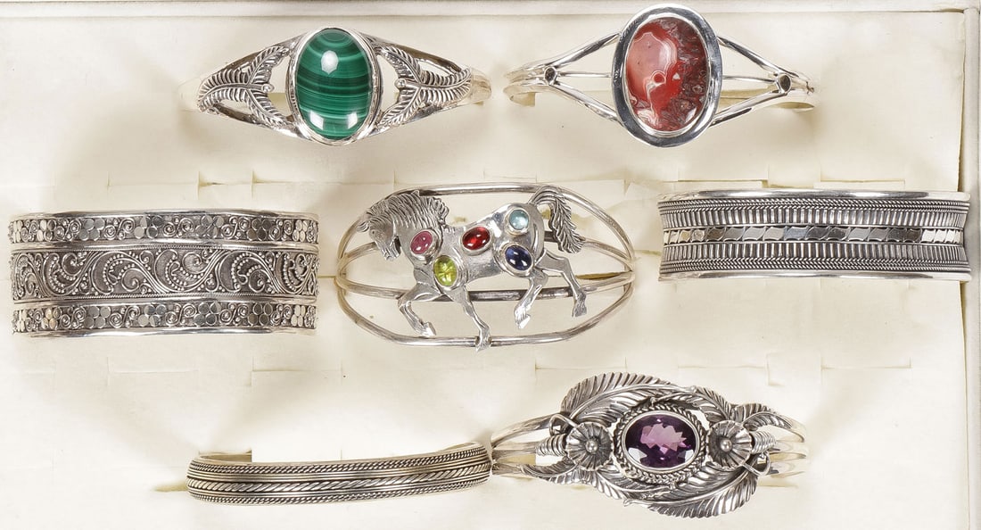 7 SILVER WESTERN STYLE BRACELETS: 7 SILVER WESTERN STYLE BRACELETS. Comprising seven silver bracelets in the Western taste as shown, some set with gemstones including African Malachite, red lace agate, amethyst and others. SHIPPING NO