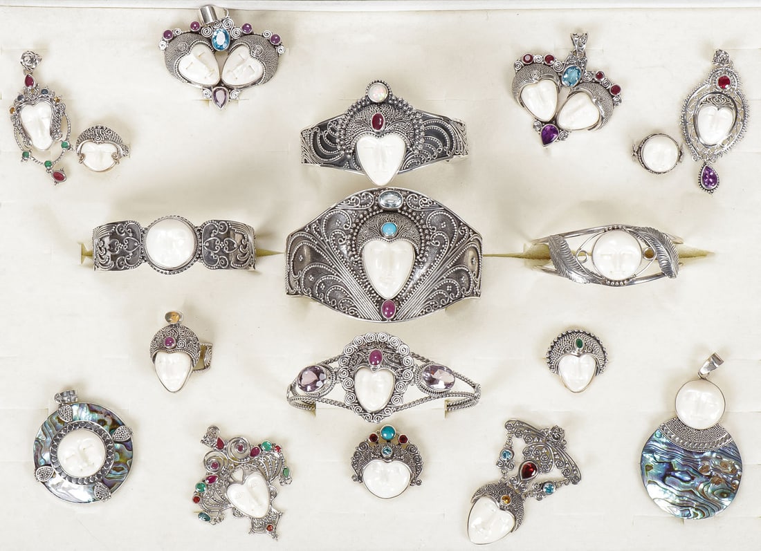 18 PC STERLING SILVER & GEMSTONE SAJEN JEWELRY: 18 PC STERLING SILVER & GEMSTONE SAJEN JEWELRY. Comprising 18 individual items including five cuff bracelets, five rings, and eight pendants, each set with a carved bone goddess or moon face, embellis