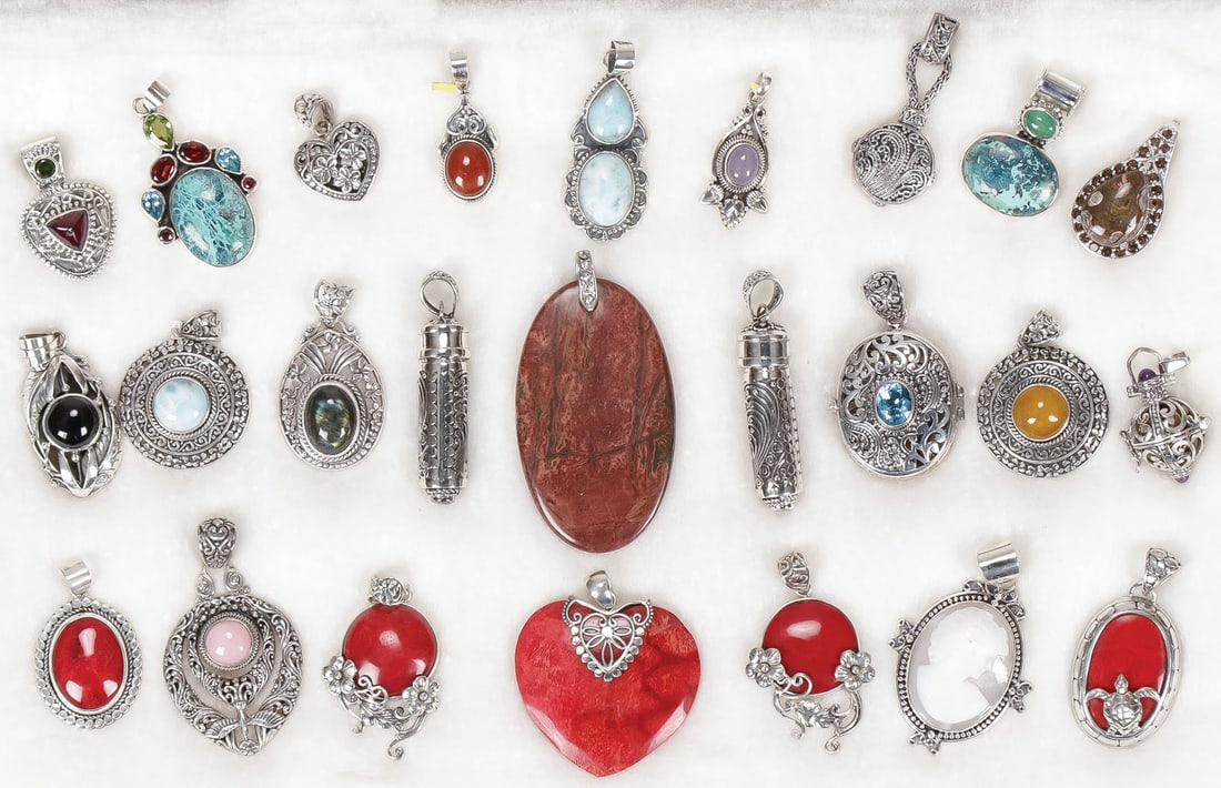 25 SILVER NECKLACE PENDANTS: 25 SILVER NECKLACE PENDANTS. Comprising 25 mostly sterling pendants, of various designs, set with a variety of semi-precious gemstones including pink opal, black spinel, blue topaz, red jade, coral, T