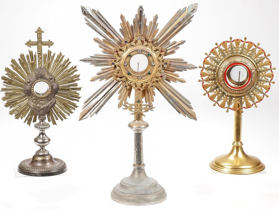 THREE ORNATE MONSTRANCES C 1890 ? 1920: THREE ORNATE MONSTRANCES C 1890 ? 1920. Each rising from conical bases with sunburst exposition windows. One with enameled decoration and the other with paste stones. Two with original lunas. Greatest