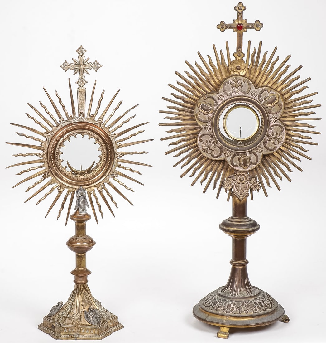 PAIR OF 19TH C MONSTRANCES: PAIR OF 19TH C MONSTRANCES. Each of gilt brass or bronze. The smaller of the two in the Gothic taste. The base set with angels and another angel below the exposition window. Both with wavy sunrays aro