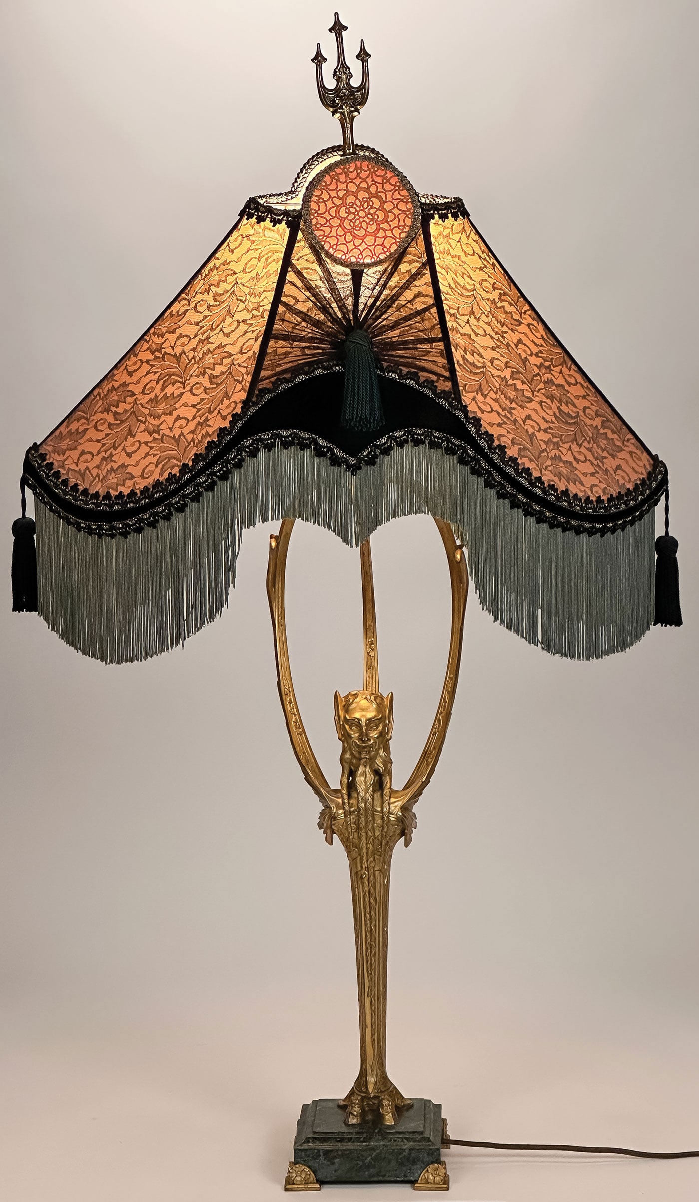 FRENCH GILT BRONZE TABLE LAMP, T. GOUJON: FRENCH GILT BRONZE TABLE LAMP, T. GOUJON. Comprising a finely sculpted gilt bronze table lamp. In the form of a bearded Bacchanalian Herme on hooved feet, with three gilt bronze arms with Art Nouveau