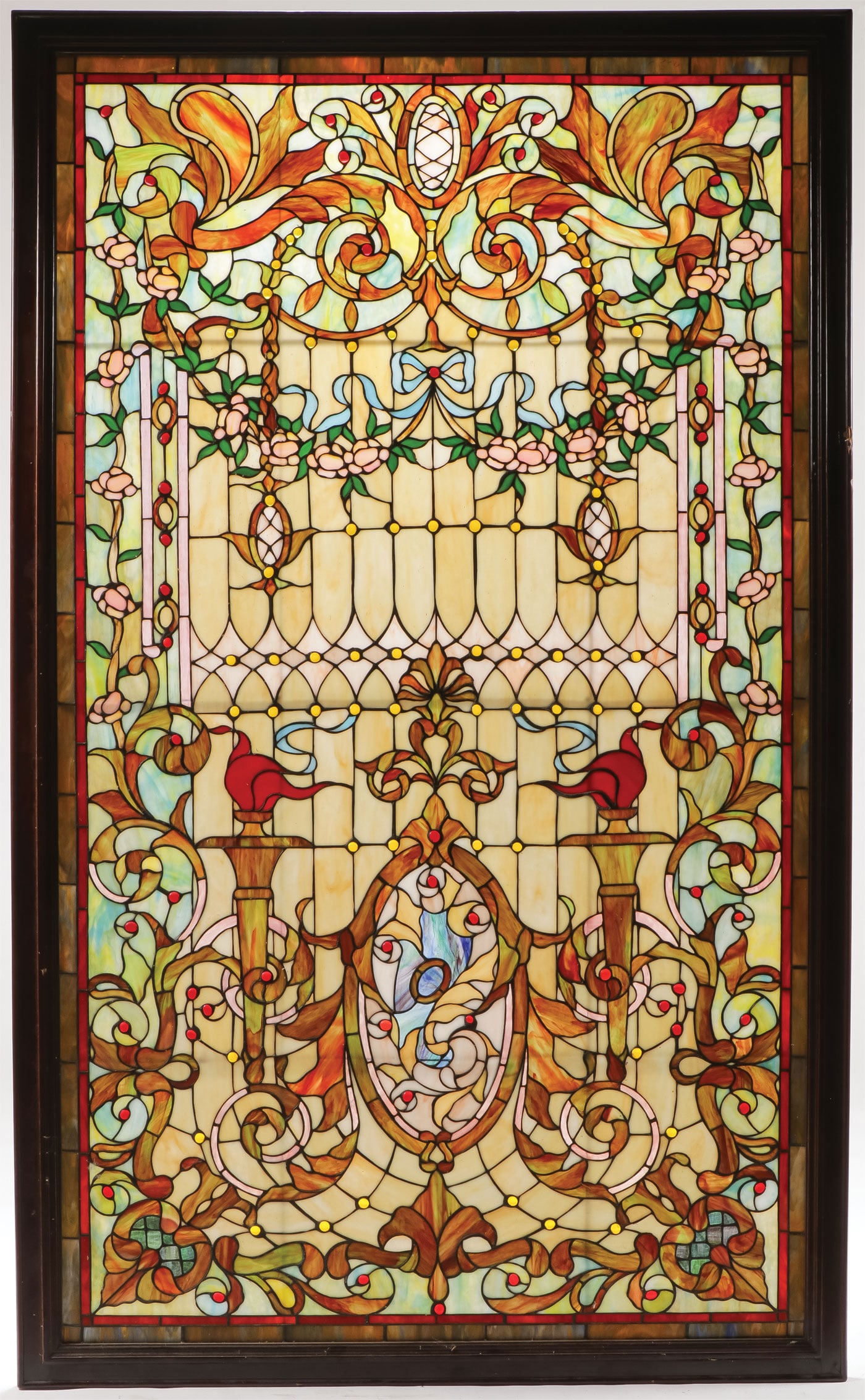 LARGE LEADED AND JEWLED GLASS WINDOW: LARGE LEADED AND JEWLED GLASS WINDOW. Comprising a large and impressive ornately designed leaded slag glass and jeweled window in wood frame. Overall 75 inches x 45.5 inches. SHIPPING NOTICE: Except f