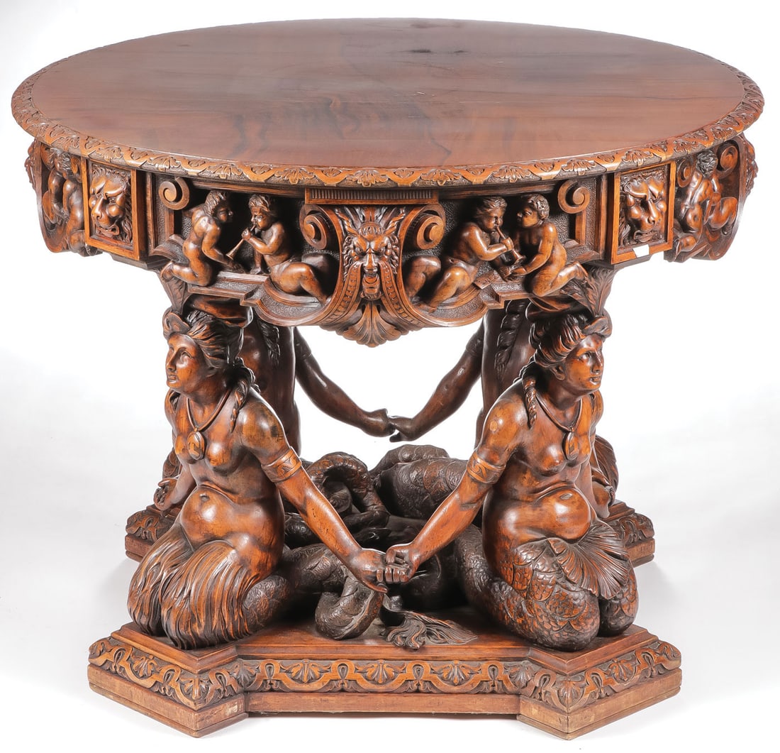 SPECTACULAR CARVED MERMAID PARLOR TABLE, C.1880: SPECTACULAR CARVED MERMAID PARLOR TABLE, C.1880. Comprising a large and impressive carved Renaissance Revival parlor table. The legs finely carved as kneeling mermaids with joined hands and extensivel