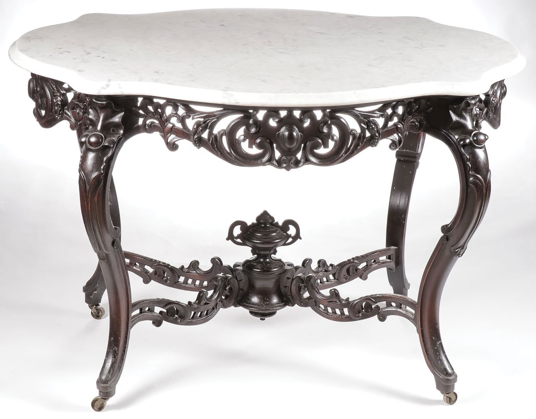 ROCOCO REVIVAL CARVED WALNUT PARLOR TABLE: ROCOCO REVIVAL CARVED WALNUT PARLOR TABLE. With carved cabriole legs, pierced carved stretcher mounted with urn, and with pierced carved skirt beneath a turtle top marble surface with beveled edge. Po