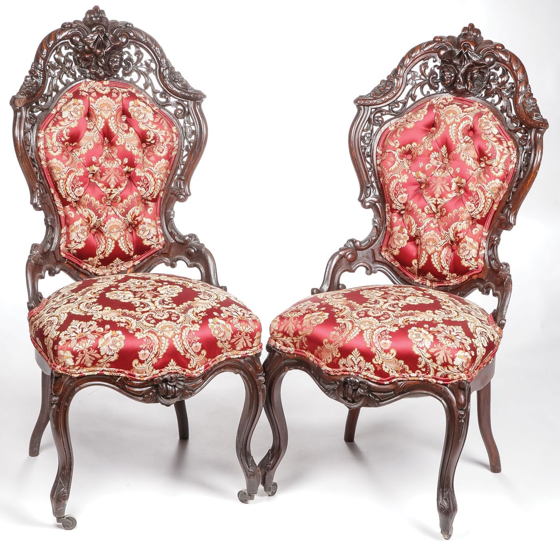 PAIR ROCOCO REVIVAL ROSEWOOD CHAIRS, MEEKS: PAIR ROCOCO REVIVAL ROSEWOOD CHAIRS, MEEKS. Comprising a pair of heavily carved rosewood chairs with pierce carved backrest terminating with flower bouquet and with padded backrest and seats. Height 3
