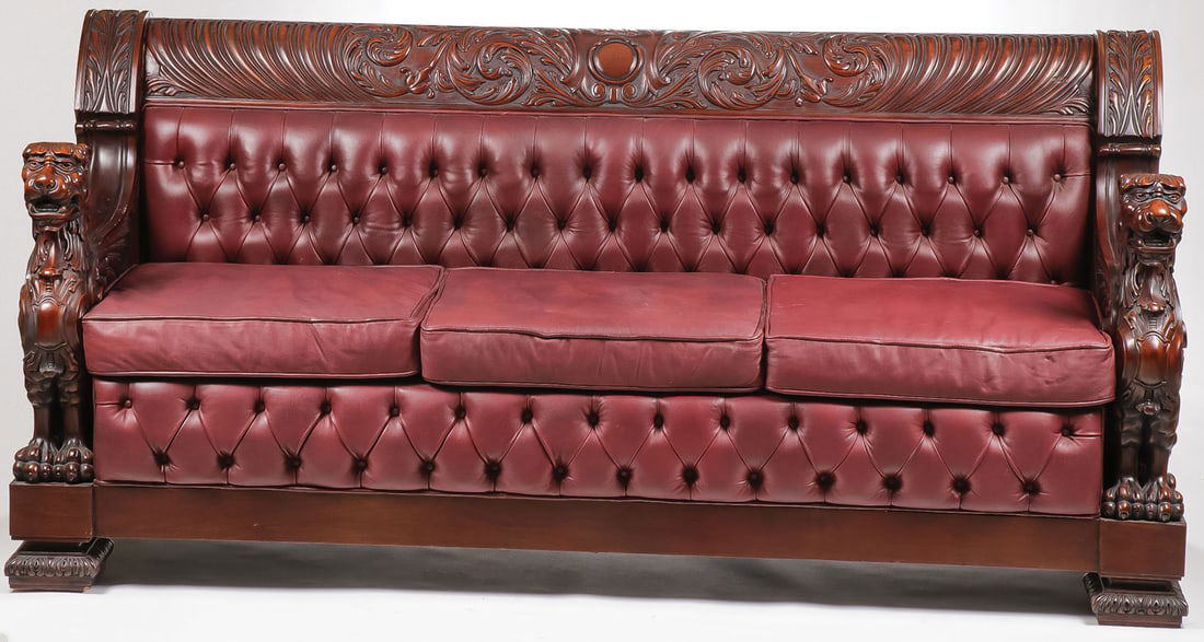 EXCEPTIONAL CARVED GENTLEMAN'S COUCH: EXCEPTIONAL CARVED GENTLEMAN'S COUCH. The ends carved with winged griffins and the back rail with center medallion flanked with rocaille scrolls. Leather button and tuck backrest and leg rest beneath