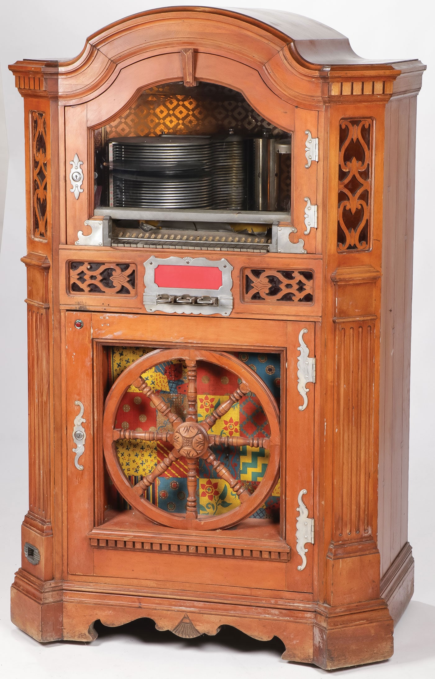 WURLITZER MODEL #780 WAGONWHEEL JUKEBOX: WURLITZER MODEL #780 WAGONWHEEL JUKEBOX. Verso with Wurlitzer Model 780 metal tag. Serial number 760737. With three-coin slots and lower-level coin return. Height 60.5 inches, width 38 inches, depth 2