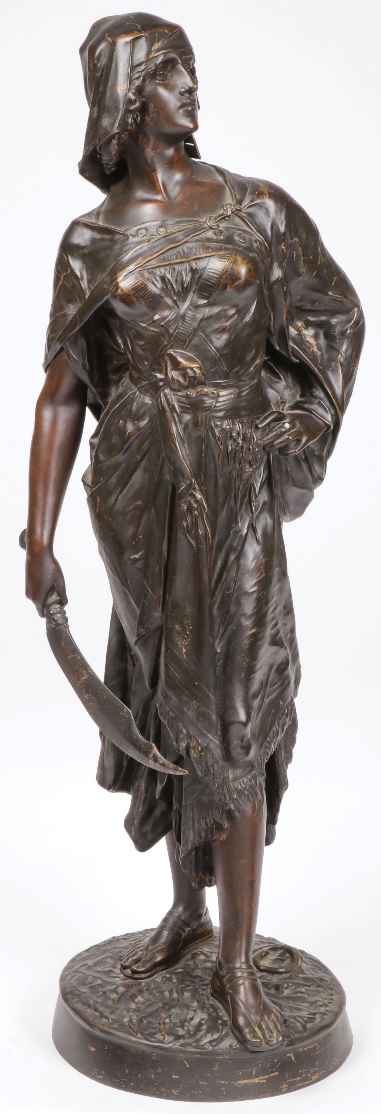 LARGE SIGNED FRENCH BRONZE OF JUDITH: EDOUARD DROUOT (French 1859-1945)Judith Bronze with dark brown patina and cabochon ringSigned on baseHeight 31.25 (79cm)The subject of the Old Testament figure of Judith was treated by a v
