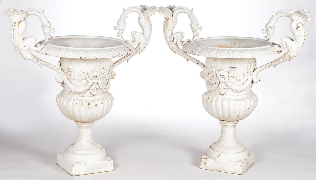 PAIR CAST IRON GARDEN URNS: PAIR CAST IRON GARDEN URNS. Of traditional form with ribbon tide garlands and the rims with opposing winged griffins or dragons. Height 37.5 inches, greatest width 36 inches. LOCAL PICKUP OR THIRD-PAR