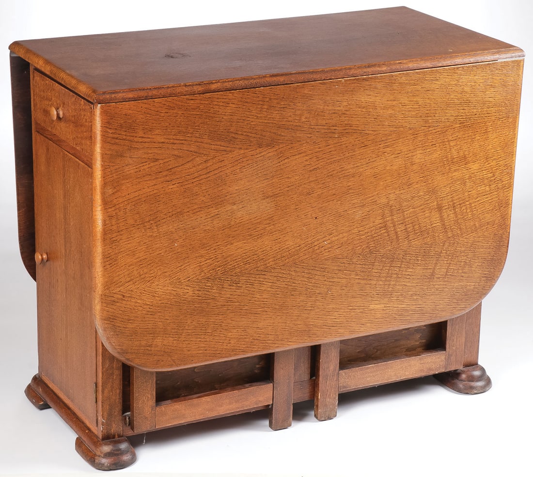 UNIQUE OAK FOLDAWAY TABLE: UNIQUE OAK FOLDAWAY TABLE. With swingout legs on both sides and one end with flatware drawer above storage door. Top surface when open 59 inches x 36 inches, height 29 inches. LOCAL PICKUP OR THIRD-PA