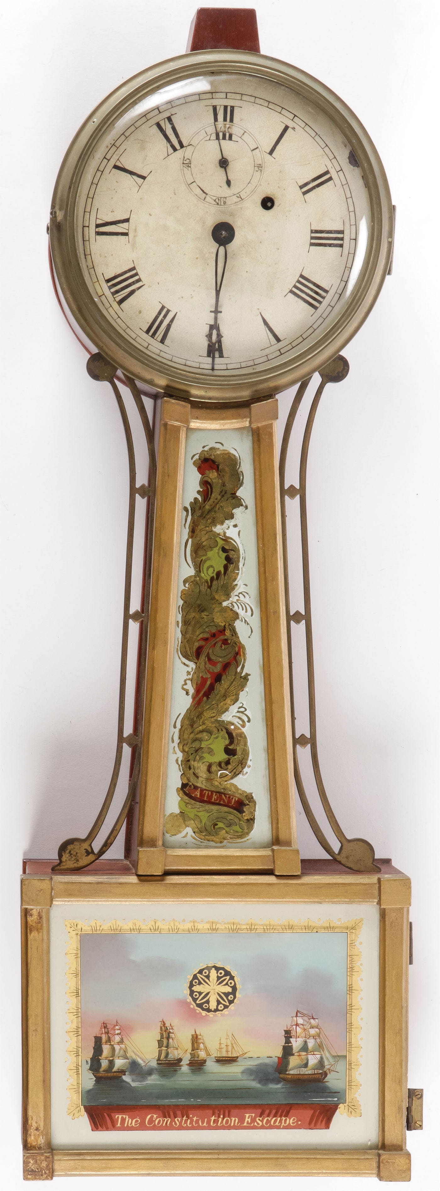 A 19TH C BANJO CLOCK: A 19TH C BANJO CLOCK. Walnut case, the dial with Roman numerals, the lower glass painted with the Constitution Escape. Height 30 inches. SHIPPING NOTICE: Except for large, oversized items, Jackson's i