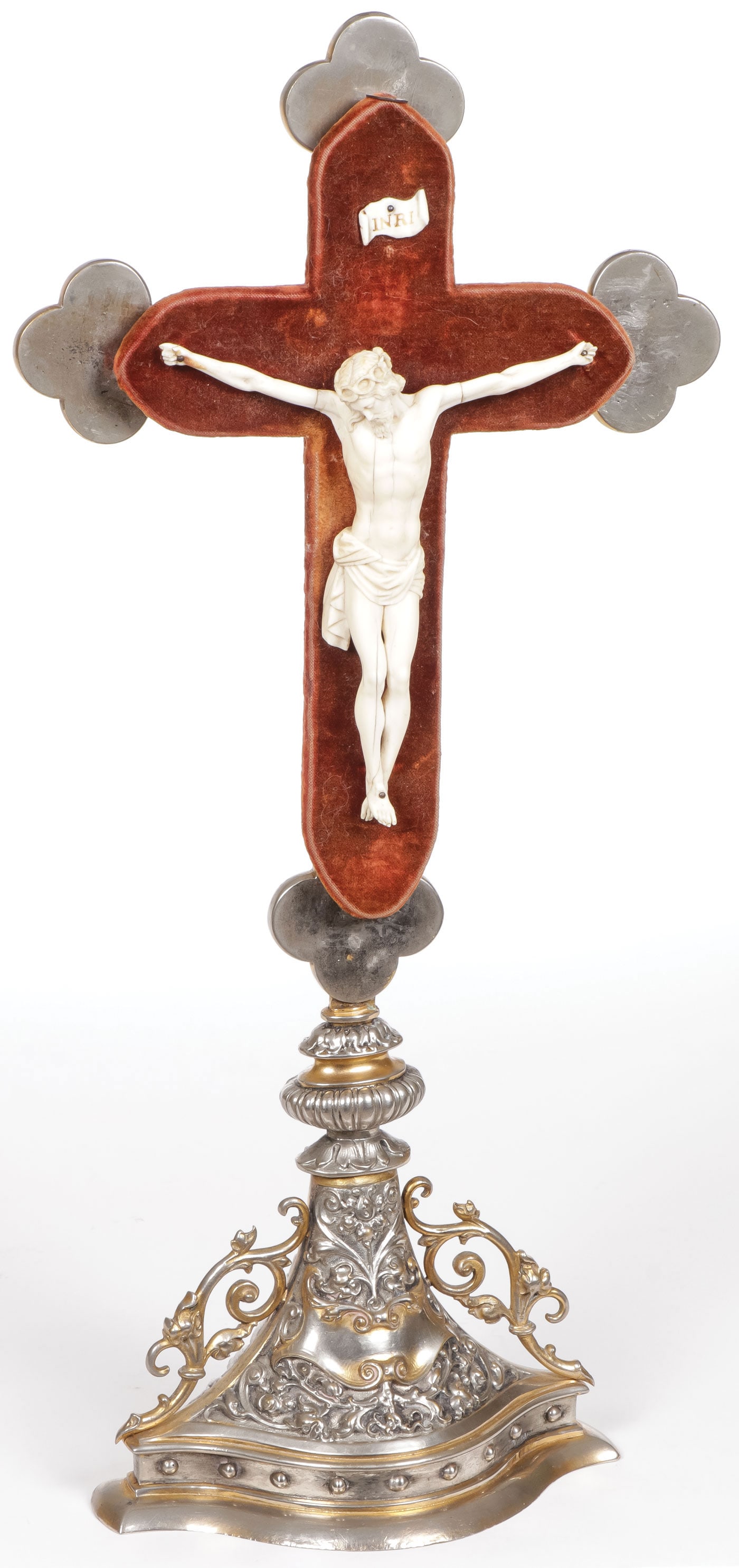 FRENCH GILT SILVERED AND CARVED ALTAR CROSS: FRENCH GILT SILVERED AND CARVED ALTAR CROSS. Comprising an ornate base supporting a cross form, the ends terminating in trefoil lobes and mounted with a carved Corpus Christi on a velvet covered cross