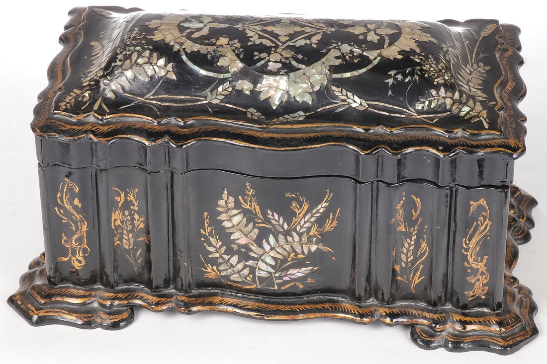 VICTORIAN LACQUERWARE TEA CADDY: VICTORIAN LACQUERWARE TEA CADDY. Comprising an ornate gilt and mother of pearl inlaid tea caddy, the hinged lid opening to reveal two side tea reserves, with amethyst glass insert. Lid unattached. Hei