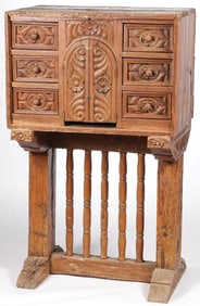 A PROVINCIAL CARVED CABINET ON STAND