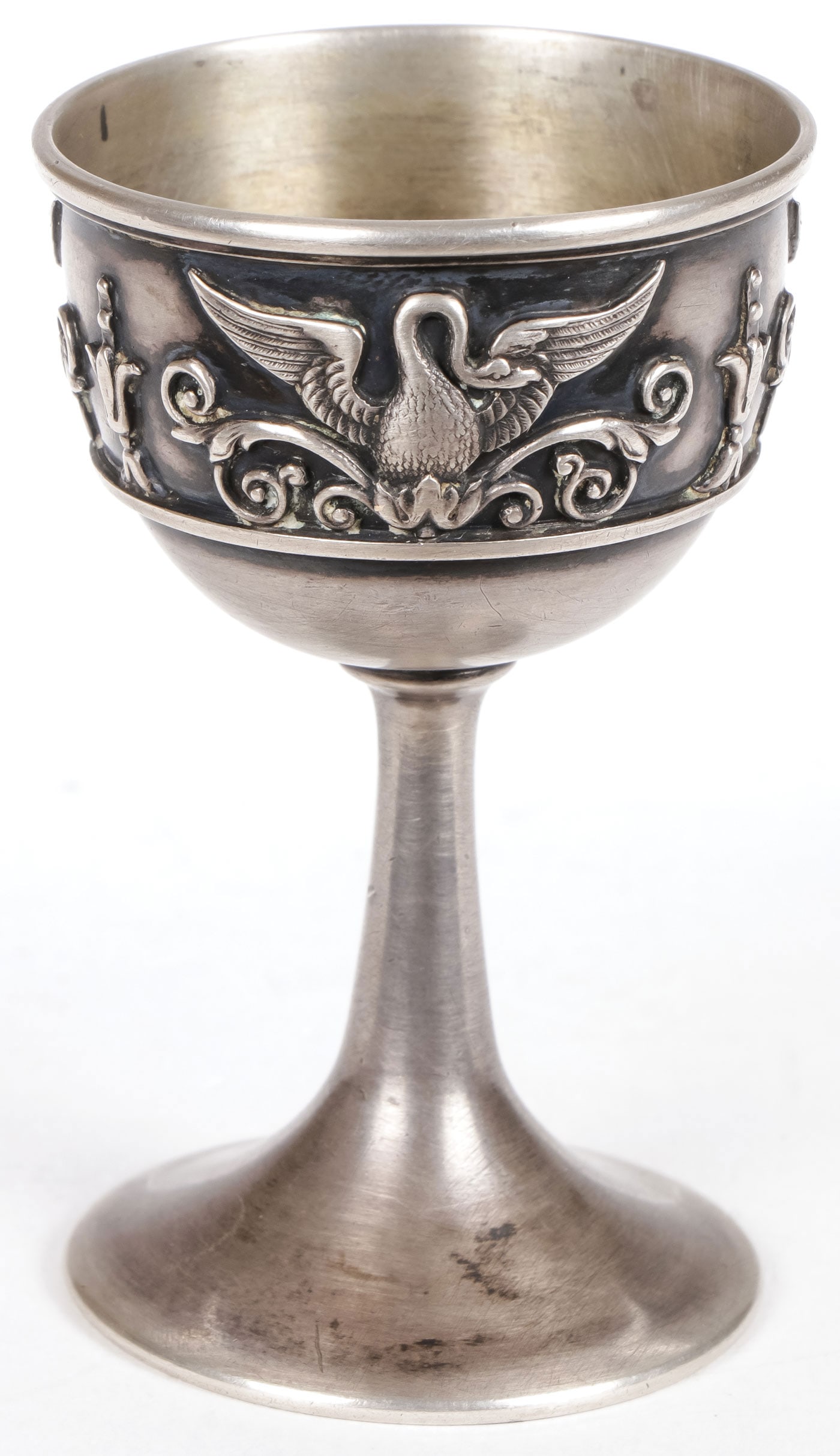 A FABERGE SILVER EGG CUP, MOSCOW C.1908: A FABERGE SILVER EGG CUP, MOSCOW C.1908. On flared stem base the sides embossed with swans with splayed wings. Hallmarked Moscow, 1908-1917, K.FABERGE in Cyrillic beneath the Imperial Warrant and 84 s