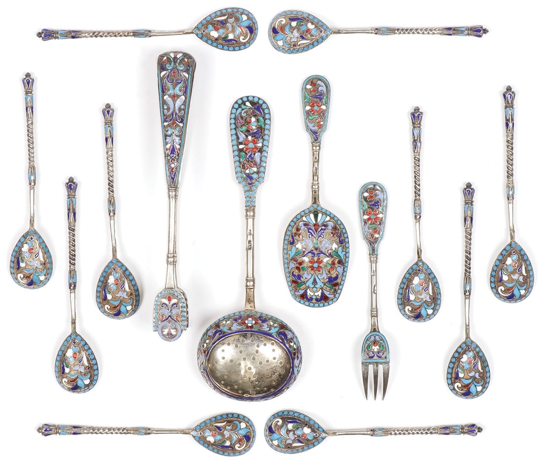 14 PIECES RUSSIAN SILVER AND ENAMEL, CIRCA 1890: 14 PIECES RUSSIAN SILVER AND ENAMEL, CIRCA 1890. Comprising 14 individual pieces including 10 matching tea spoons, sugar tongs, a tea strainer, sugar scoop and pickle fork. Various makers, all with 84